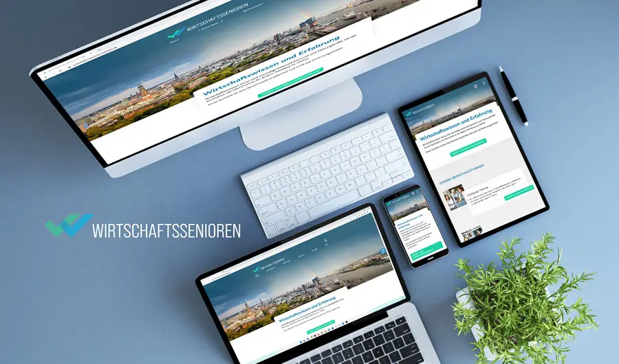 WIRTSCHAFTSENIOREN Website Webdesign auf Geräten neben einer Grünanlage in Winsen bei Hamburg.